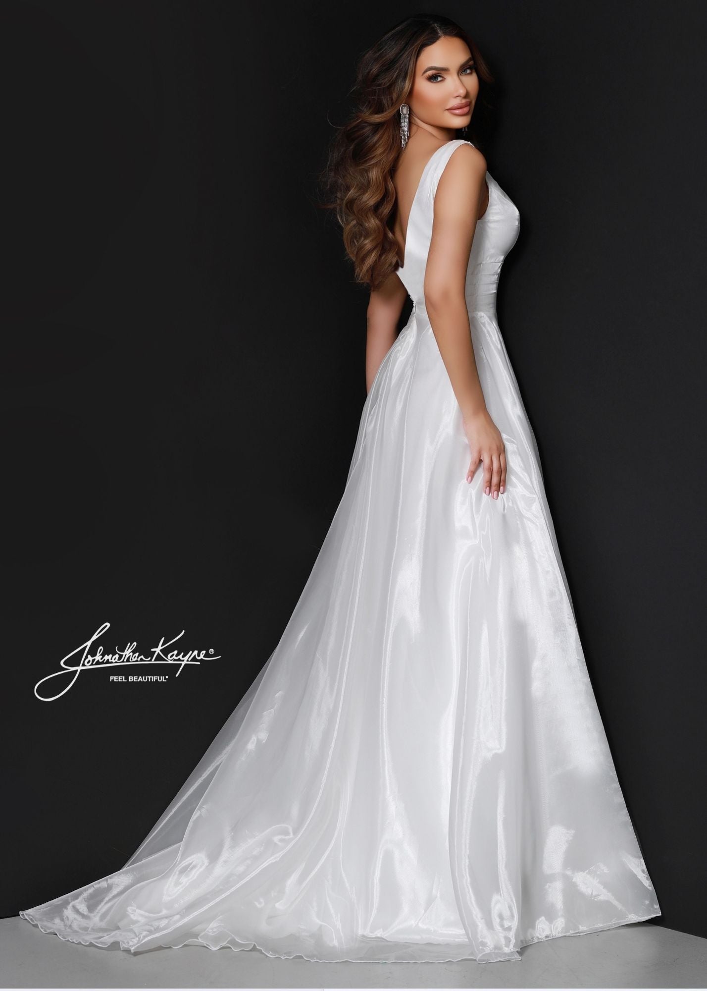 Johnathan Kayne's 2538 wedding dress is the perfect destination bridal gown for the modern bride. The sleek A-line fit, V-neck, and slit create a stylish and timeless look. This piece is sure to make a statement.  Size: 0, 14  Color: White