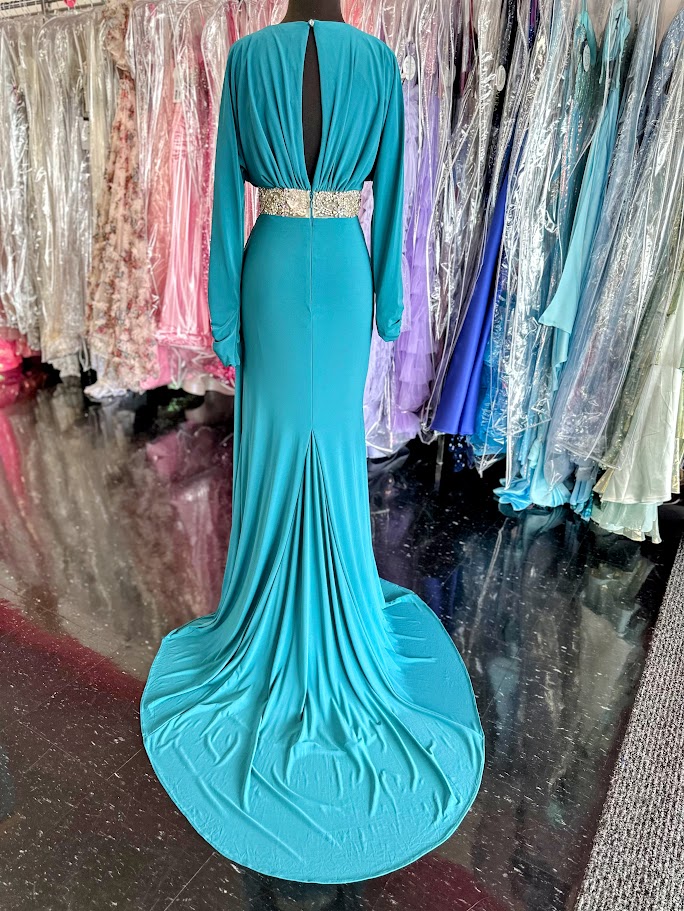 Elevate your evening with the Johnathan Kayne 2685 long sleeve formal gown in a stunning teal hue. This size 4 dress features a high slit that adds a touch of allure, while delicate crystal and sheer beading embellishments create an exquisite, sophisticated shimmer. Perfect for making a graceful statement at any formal event.

Size: 4

Color: Teal