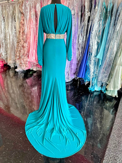 Elevate your evening with the Johnathan Kayne 2685 long sleeve formal gown in a stunning teal hue. This size 4 dress features a high slit that adds a touch of allure, while delicate crystal and sheer beading embellishments create an exquisite, sophisticated shimmer. Perfect for making a graceful statement at any formal event.

Size: 4

Color: Teal