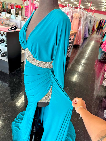 Elevate your evening with the Johnathan Kayne 2685 long sleeve formal gown in a stunning teal hue. This size 4 dress features a high slit that adds a touch of allure, while delicate crystal and sheer beading embellishments create an exquisite, sophisticated shimmer. Perfect for making a graceful statement at any formal event.

Size: 4

Color: Teal