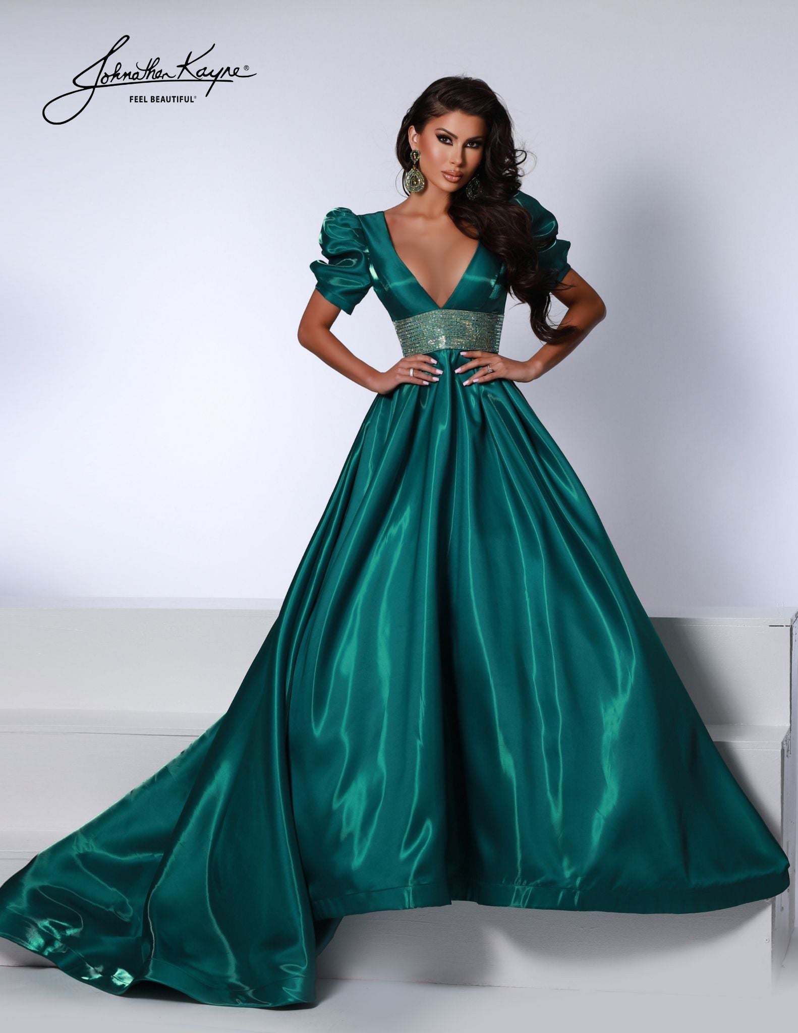 Johnathan Kayne 2692 Shimmer Satin A Line Puff Sleeve Prom Dress Crystal Waist Pageant Gown One of our best sellers from the fall, but LONG! This shimmer satin gown has puff sleeves and a V-neck bodice with a thick crystal trim waist band. Did we mention it has pockets?  Sizes: 00-24  Colors: Aqua, Cherry, Black, White, Emerald 