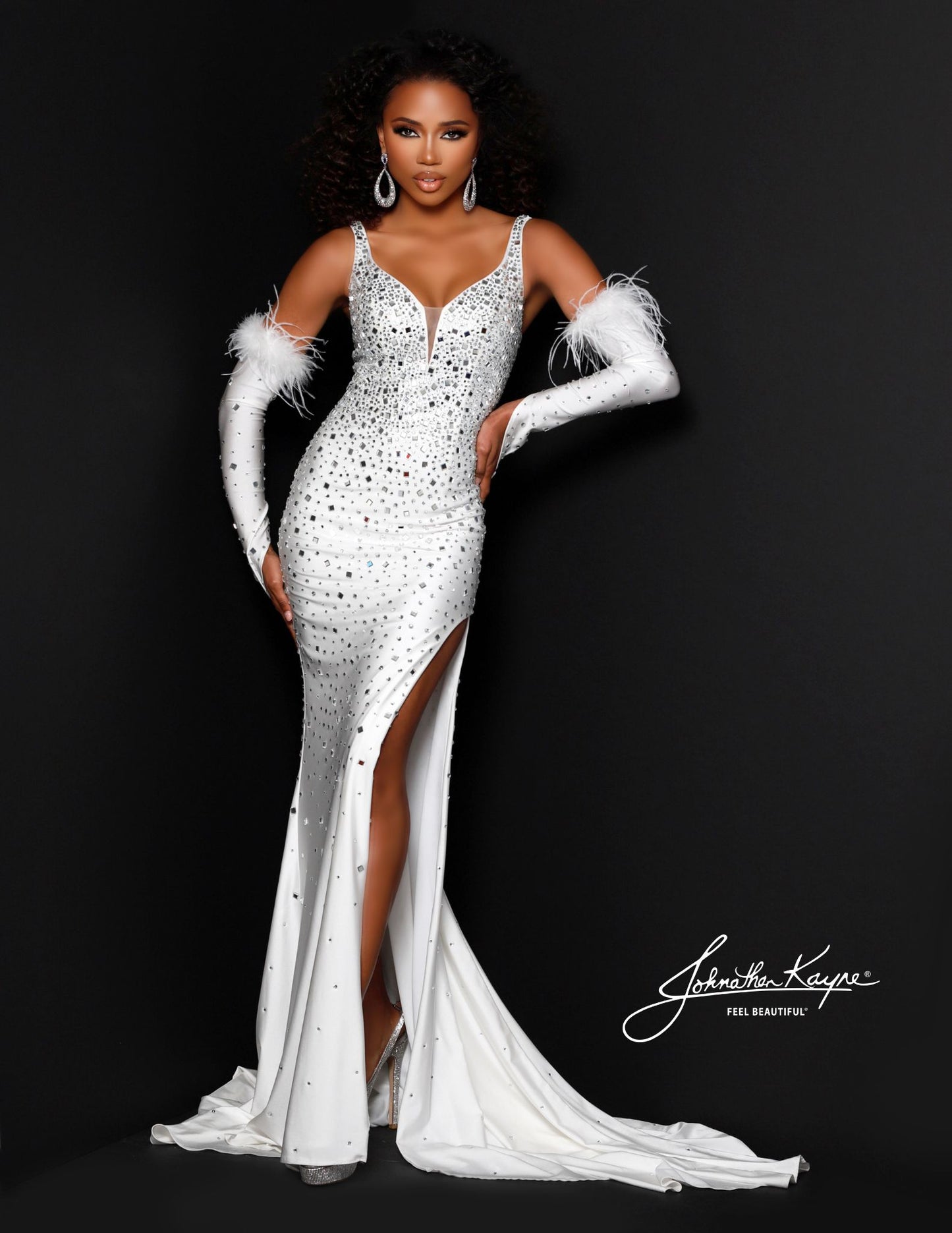 Be dazzling in this Johnathan Kayne 2720 evening gown. Its sleek crystal jersey bodice, Feathered trimmed glove sleeves, and graceful jersey skirt with a high slit create a silhouette that will turn heads wherever you go. Make your mark with this unforgettable style.   Sizes: 00,0,2,4,6,8,10,12,14,16  Colors: Black, Silver, Red, White , Royal