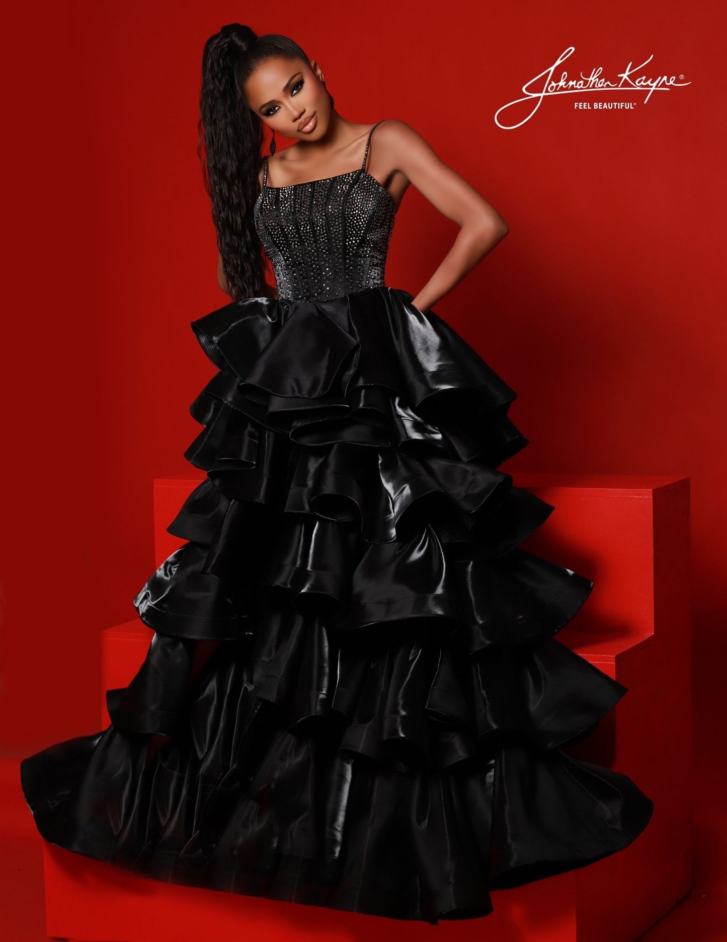 Johnathan Kayne 2721 This tiered ruffle high low skirt in this gown is a show stopper crystal stone corset front bodice is absolutely stunning made of shimmer satin to give a little shine  Sizes: 00,0,2,4,6,8,10,12,14,16  Colors: Black, Red