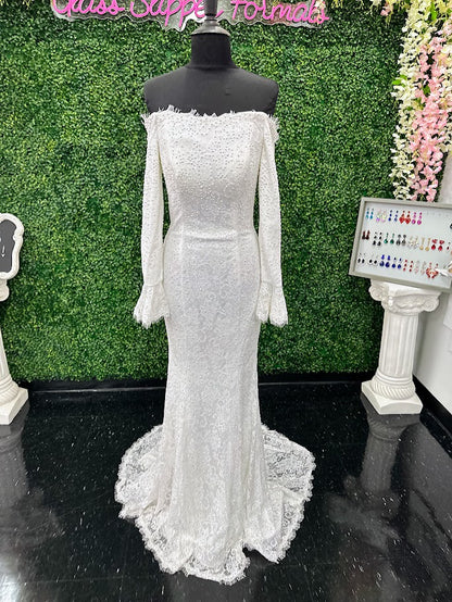 This exquisite Johnathan Kayne gown in size 4 features a long, fitted silhouette crafted from delicate white lace. Designed with an off-the-shoulder neckline and long sleeves ending in elegant ruffle cuffs, it offers a refined and sophisticated look. The dress is adorned with AB crystals that add subtle sparkle, while the eyelash lace edges and flowing train enhance its graceful presence, making it an ideal choice for pageants or formal events.

Size: 4

Color: White