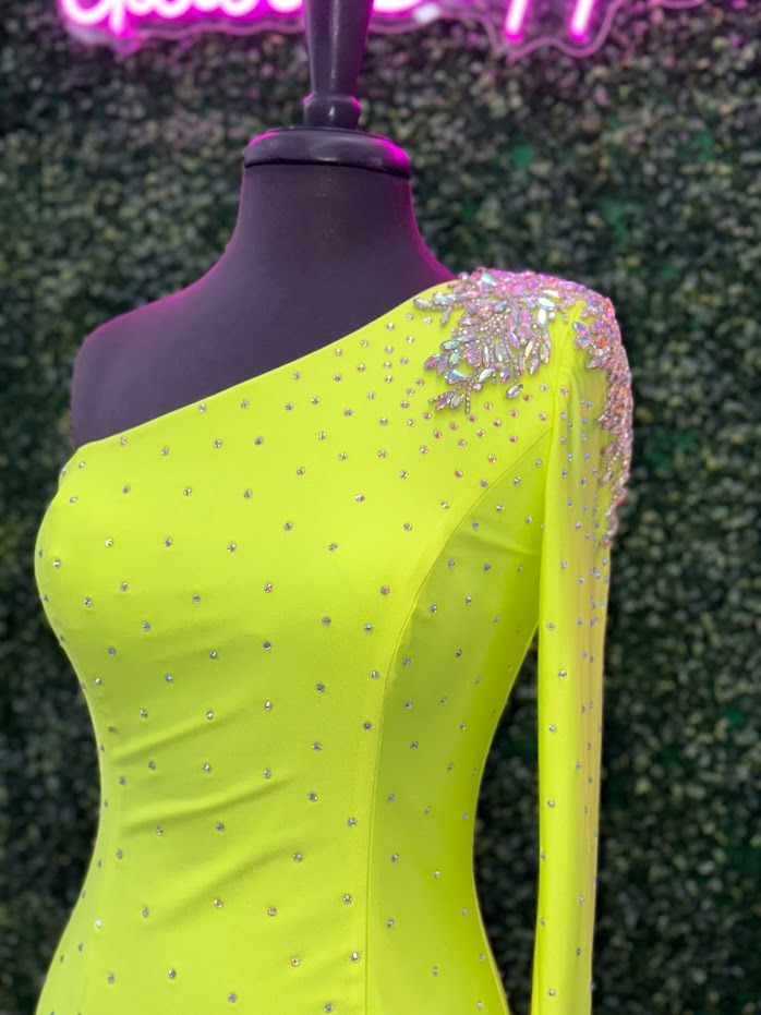 This Johnathan Kayne 2785 dress is perfect for your homecoming event. It features a single crystal shoulder, long sleeve with crystal wrist line, and stoned bodice for a sparkling look. It is also fitted for a flattering silhouette. Perfect for a memorable night.  Sizes: 4  Colors: Neon Green