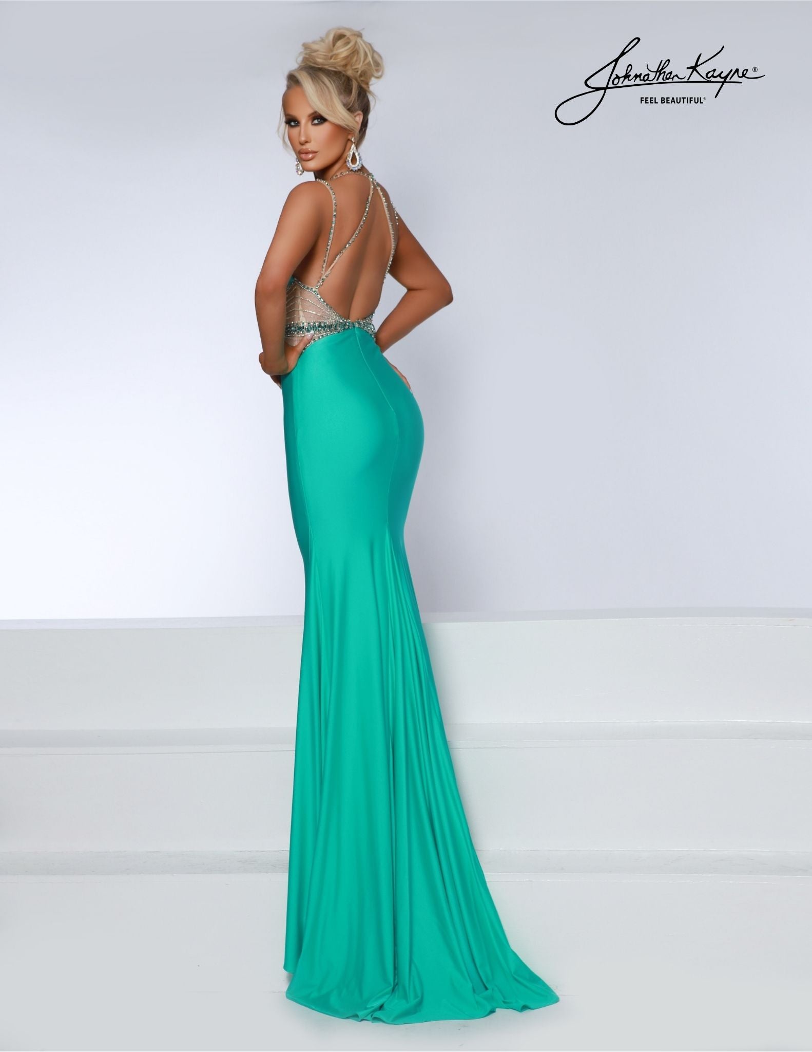 Johnathan Kayne 2808 long prom dress features a stunning beaded design, sheer side cut-outs and a deep V neckline. The perfect formal gown for pageants, dances, and special occasions. Experience elegance and comfort in this 4-Way Stretch Lycra gown. The beaded sheer side cut-outs and deep V neckline create a sultry, stylish look for any special occasion.