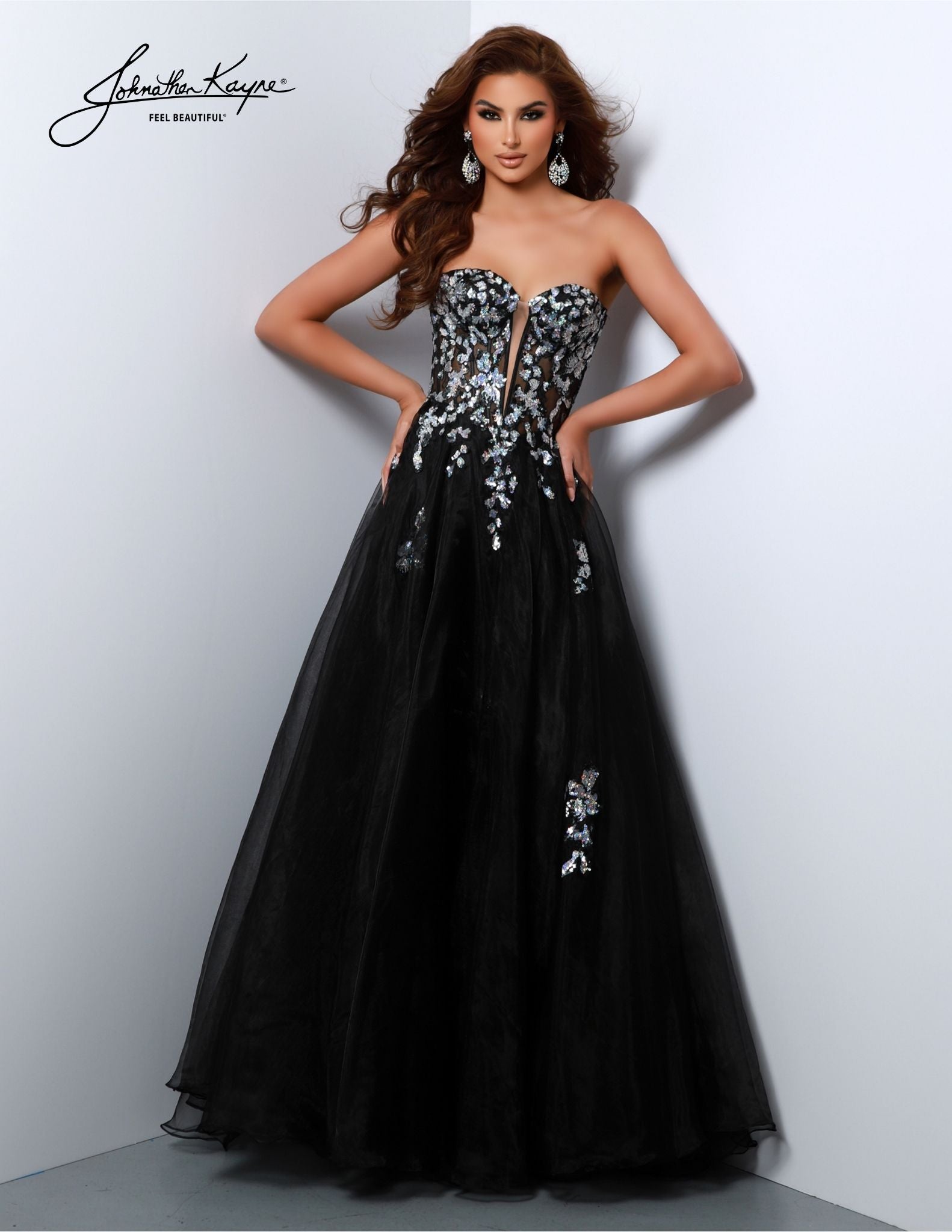 Make a statement in the Johnathan Kayne 2809 Long Prom Dress. This beautiful full-length gown features a sheer sequin corset bodice with a formal A-line skirt in a flattering silhouette. Turn heads at your prom or pageant in this stunning gown. Elegance meets untamed beauty in this ballgown. The captivating sequin detailing adds a dash of fierce to your already enchanting presence. 