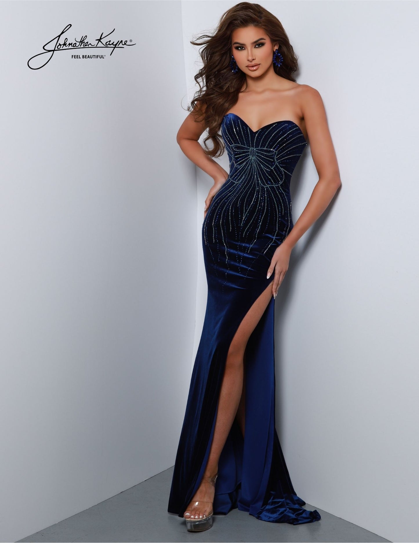 Johnathan Kayne 2822 offers a timeless look, crafted with stretch velvet and a luxurious strapless sweetheart neckline. This elegant understated gown features a high slit to create an alluring silhouette suitable for any formal event. Its classic styling and superior craftsmanship will ensure you look and feel amazing. It's a bow-tiful masterpiece! 