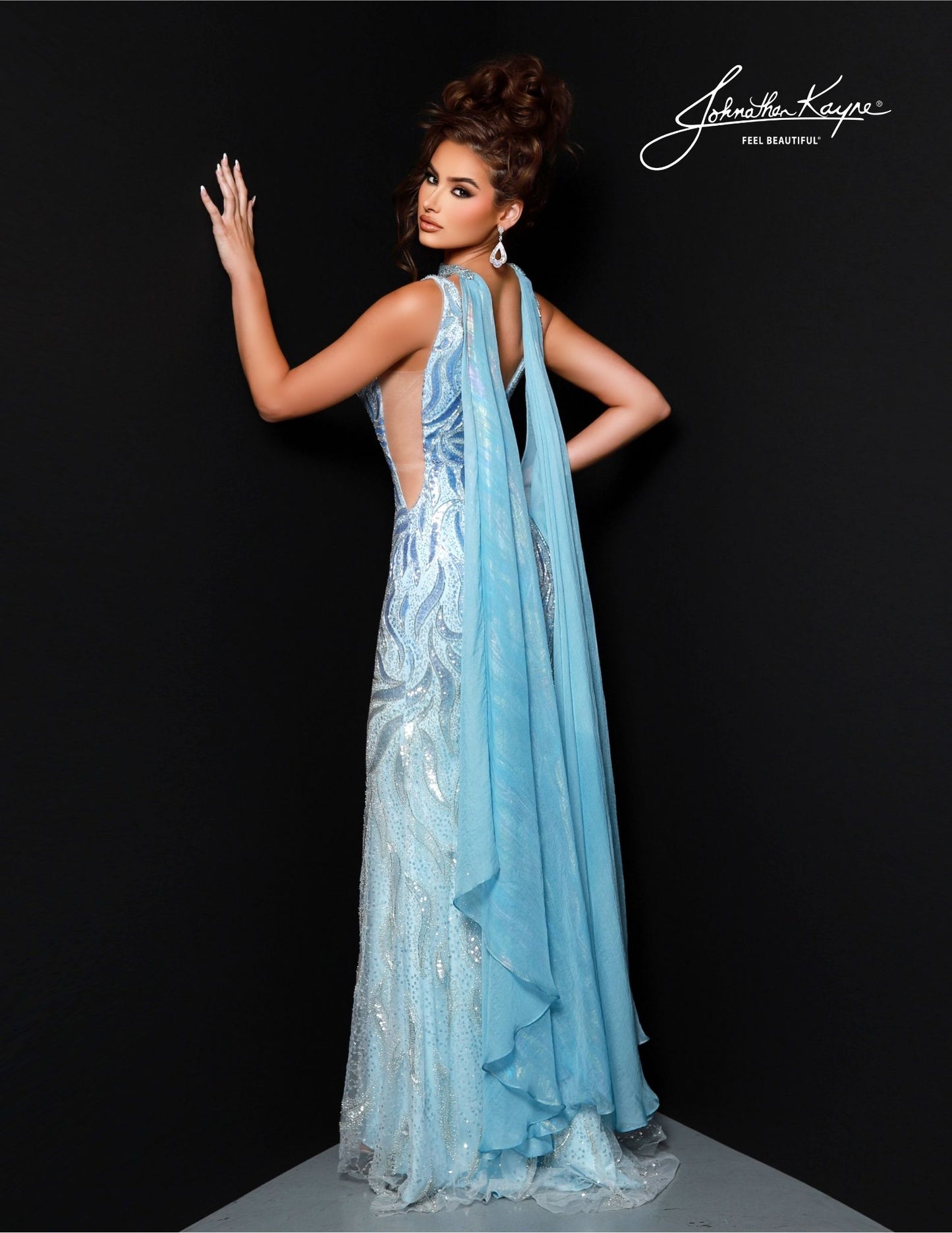 Johnathan Kayne's 2824 Long Prom Dress is perfect for a formal event. Crafted with a flattering mermaid silhouette and beaded choker cape, this elegant gown features a V-neckline, fitted waist and full-length hem. Ideal for pageants or proms. Drape yourself in luxury! This stunning gown features intricate beadwork on a mesh overlay, providing a captivating, shimmering effect. The detachable cape with choker adds a touch of drama and sophistication.