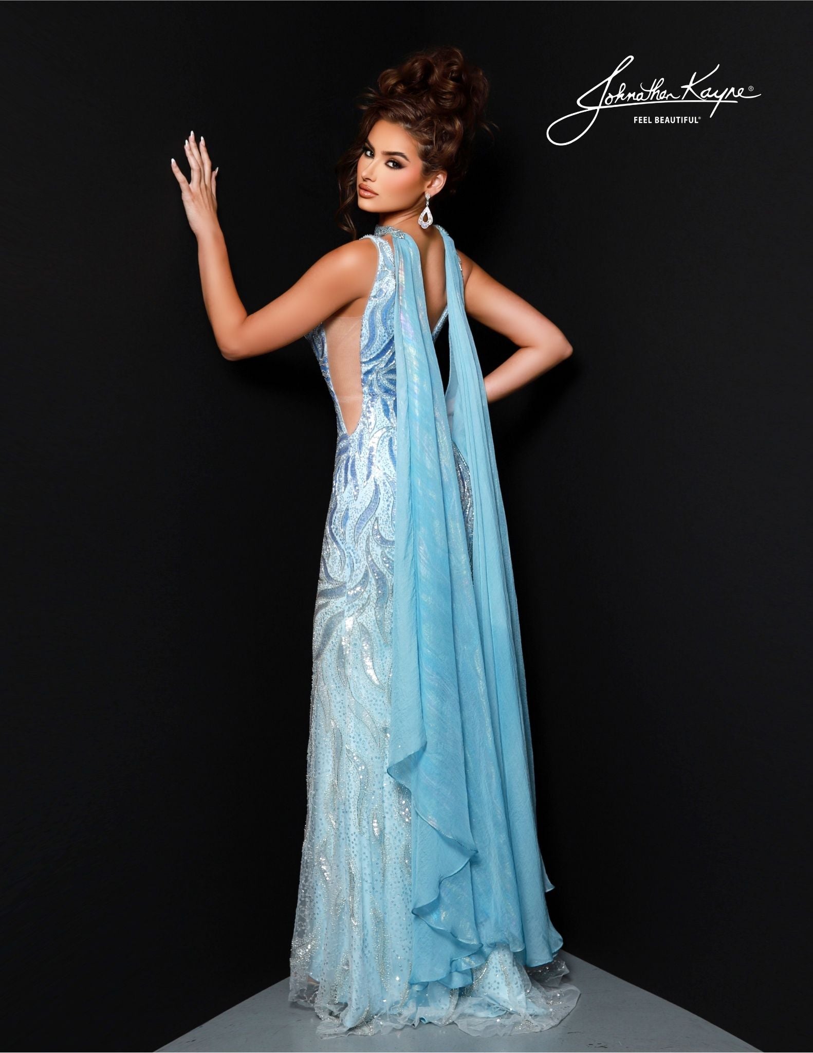 Johnathan Kayne's 2824 Long Prom Dress is perfect for a formal event. Crafted with a flattering mermaid silhouette and beaded choker cape, this elegant gown features a V-neckline, fitted waist and full-length hem. Ideal for pageants or proms. Drape yourself in luxury! This stunning gown features intricate beadwork on a mesh overlay, providing a captivating, shimmering effect. The detachable cape with choker adds a touch of drama and sophistication.