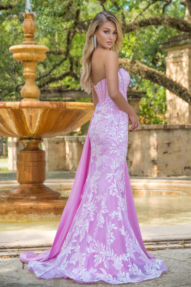 Elevate your formal attire with the Ava Presley 28291 Long Prom Dress. This strapless gown features a flattering corset design, charming side drape, and elegant train. Made with luxurious charmeuse fabric, it exudes sophistication and grace. Perfect for pageants, proms, or any special occasion.