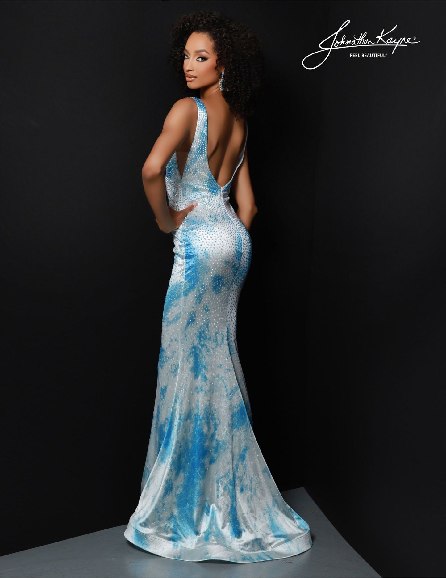 Johnathan Kayne 2831 is a long, formal mermaid gown perfect for all your special occasions. This elegant V Neck design is adorned with gorgeous sequins for a sparkling look and is sure to make you feel like the belle of the ball. Show off your curves with this stunningly beautiful dress for an unforgettable night! Get ready to steal the show in our best-selling silhouette, now adorned in a printed shiny Lycra gown. This piece promises to illuminate every room you enter.