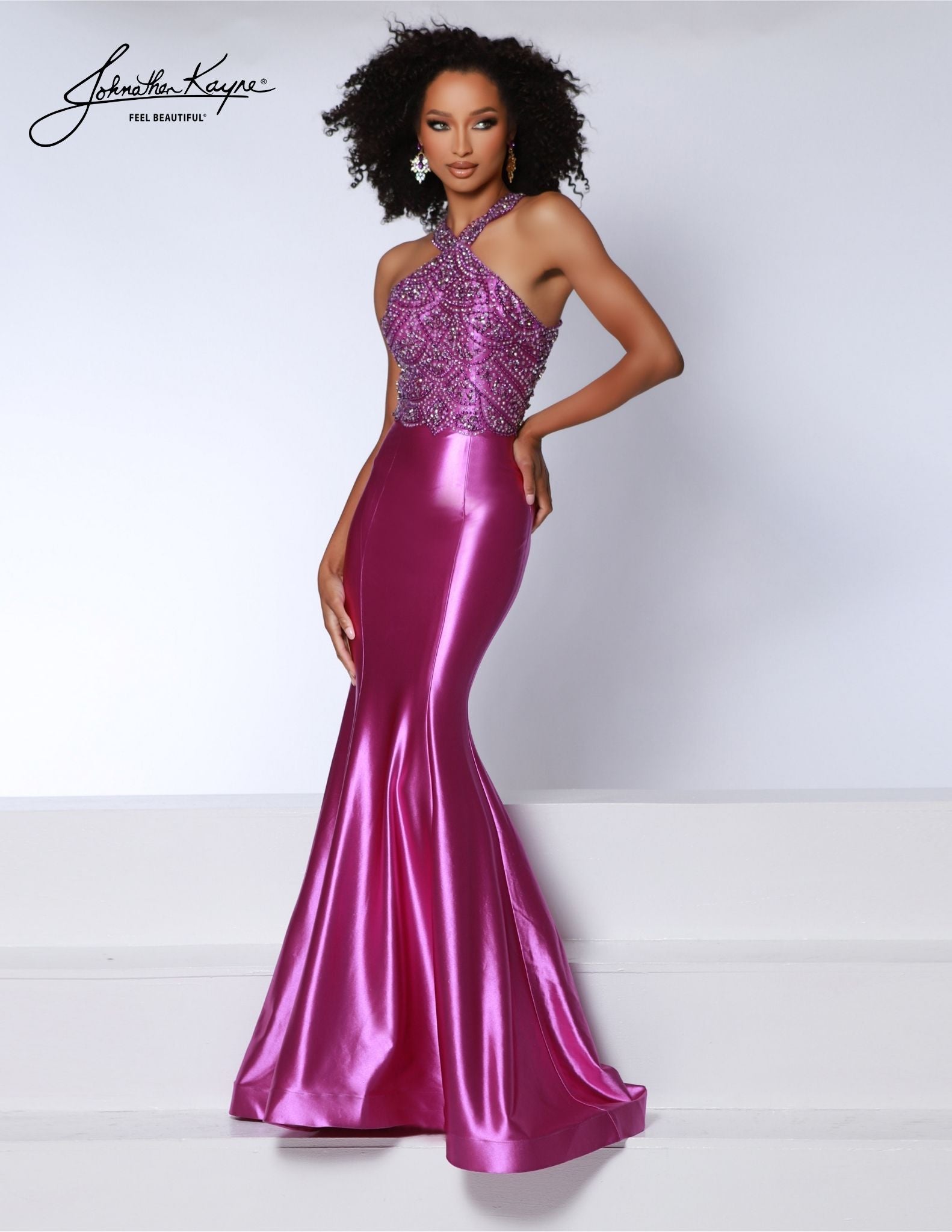 Johnathan Kayne 2839 Long Prom Dress is a stunning formal gown crafted with exquisite beadwork. Showcasing a halter neckline and an open back, it's a glamorous choice for prom or pageant. The mermaid silhouette creates a stunning look with every step. 