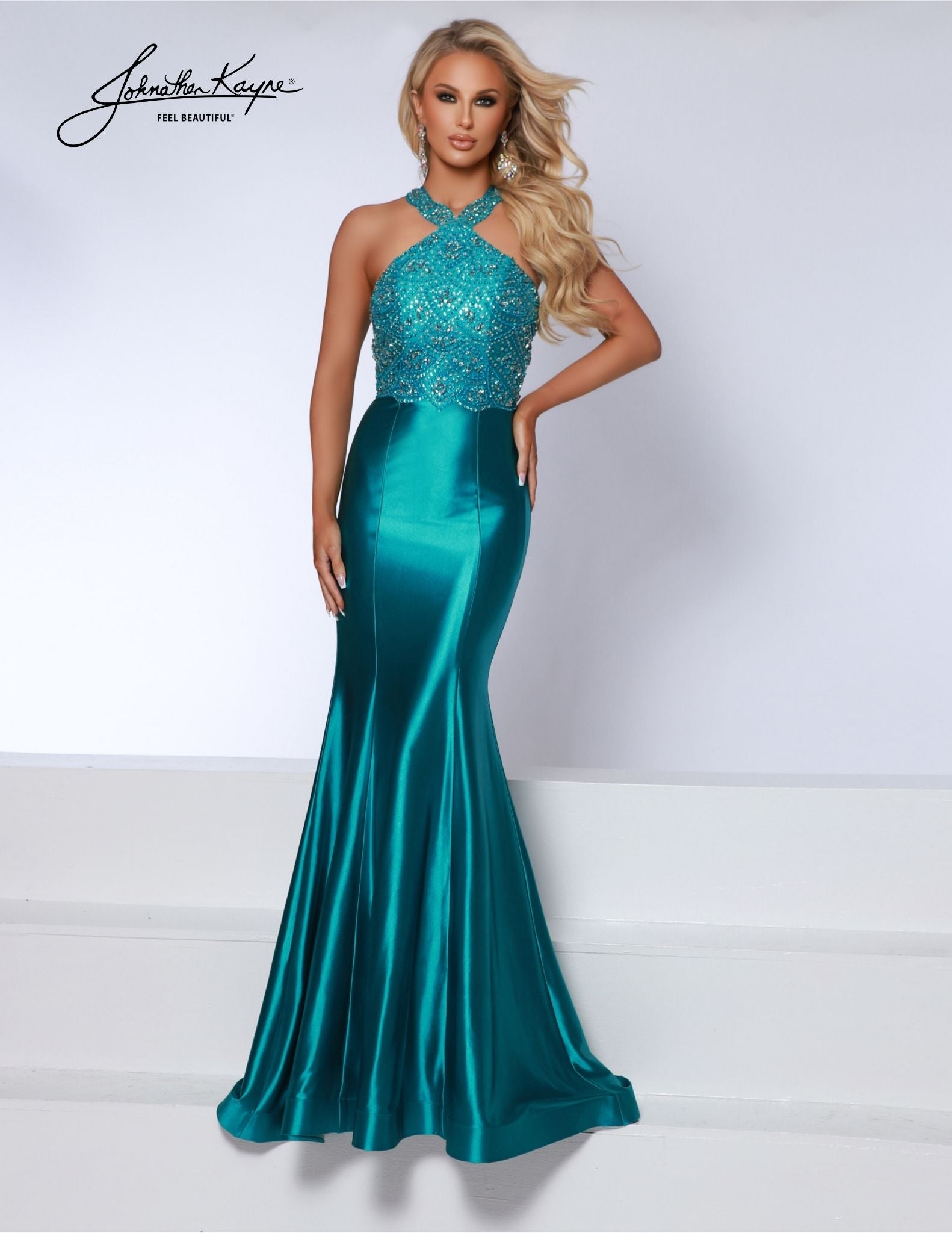 Johnathan Kayne 2839 Long Prom Dress is a stunning formal gown crafted with exquisite beadwork. Showcasing a halter neckline and an open back, it's a glamorous choice for prom or pageant. The mermaid silhouette creates a stunning look with every step. 