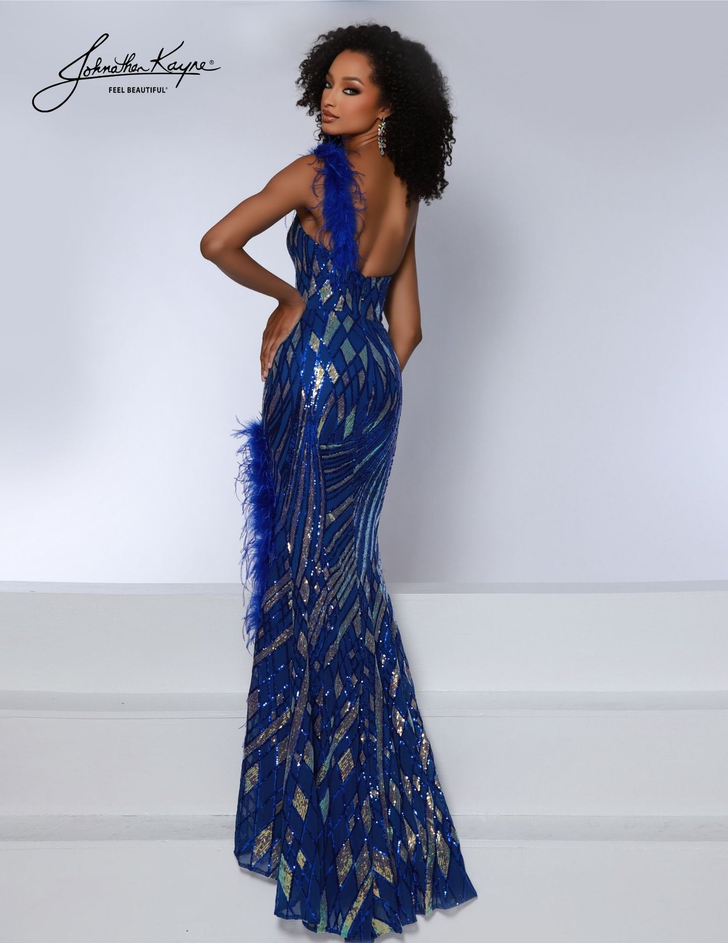 Look stunning in the Johnathan Kayne 2844 Long Prom Dress. This fitted one-shoulder gown features a delicate sequin powermesh, slit details feathers for a striking look. Perfect for an elegant night on the town or any formal occasion. Prepare to steal the show! This one-shoulder wonder is adorned with mesmerizing sequins that shimmer and sparkle, ensuring you radiate elegance and glamour. 