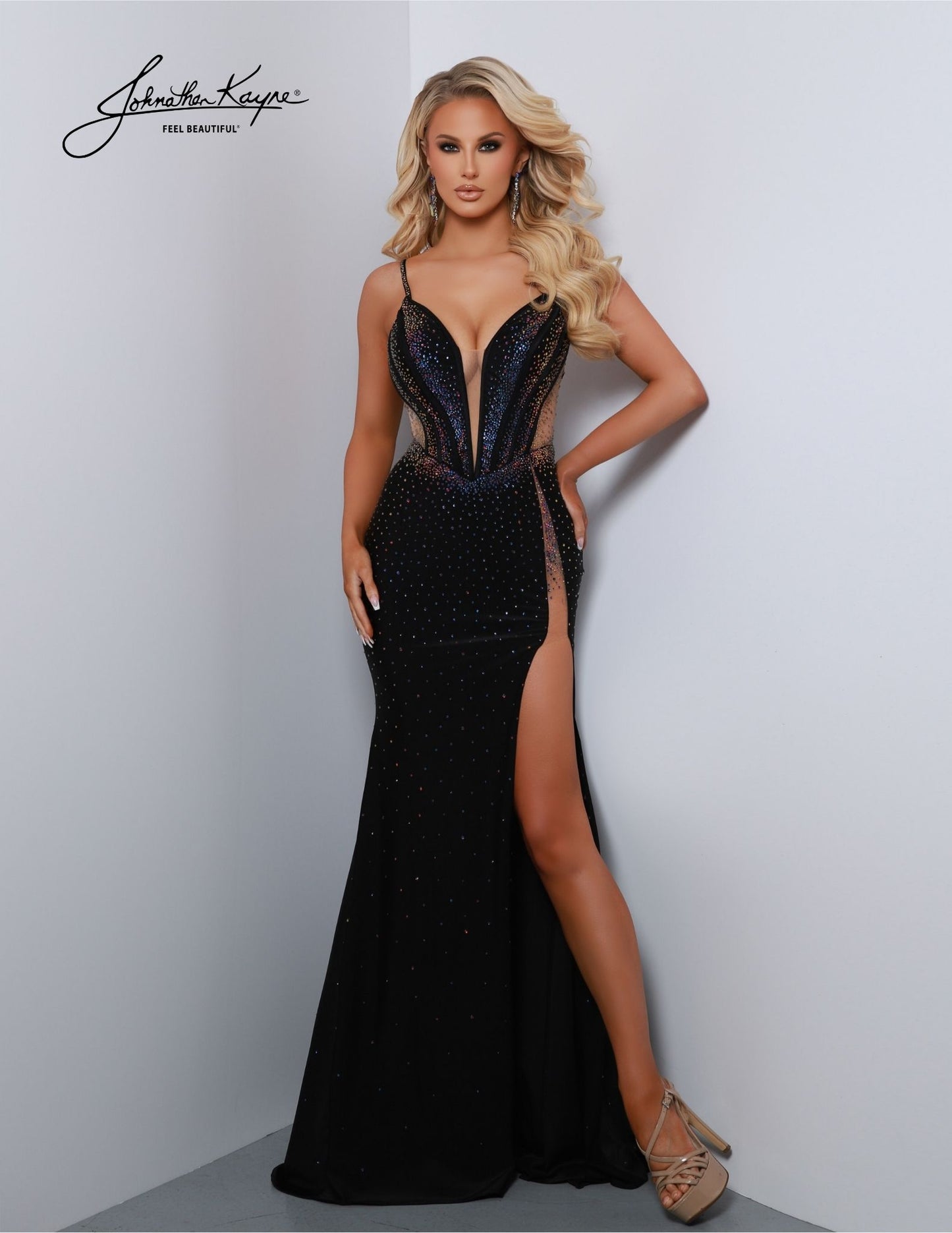 This elegant dress from Johnathan Kayne 2851 is sure to make you look and feel your best. Featuring a fitted Lycra bodice and beaded V-neck plunging neckline, the gown is both glamorous and timeless. It also features a long maxi slit with mesh detailing, perfect for any formal or pageant occasion. Make jaws DROP! This exquisite 4 Way Stretch Lycra gown features a thigh-high slit, a beaded bodice with exposed boning, and a design that's destined to captivate and command attention.