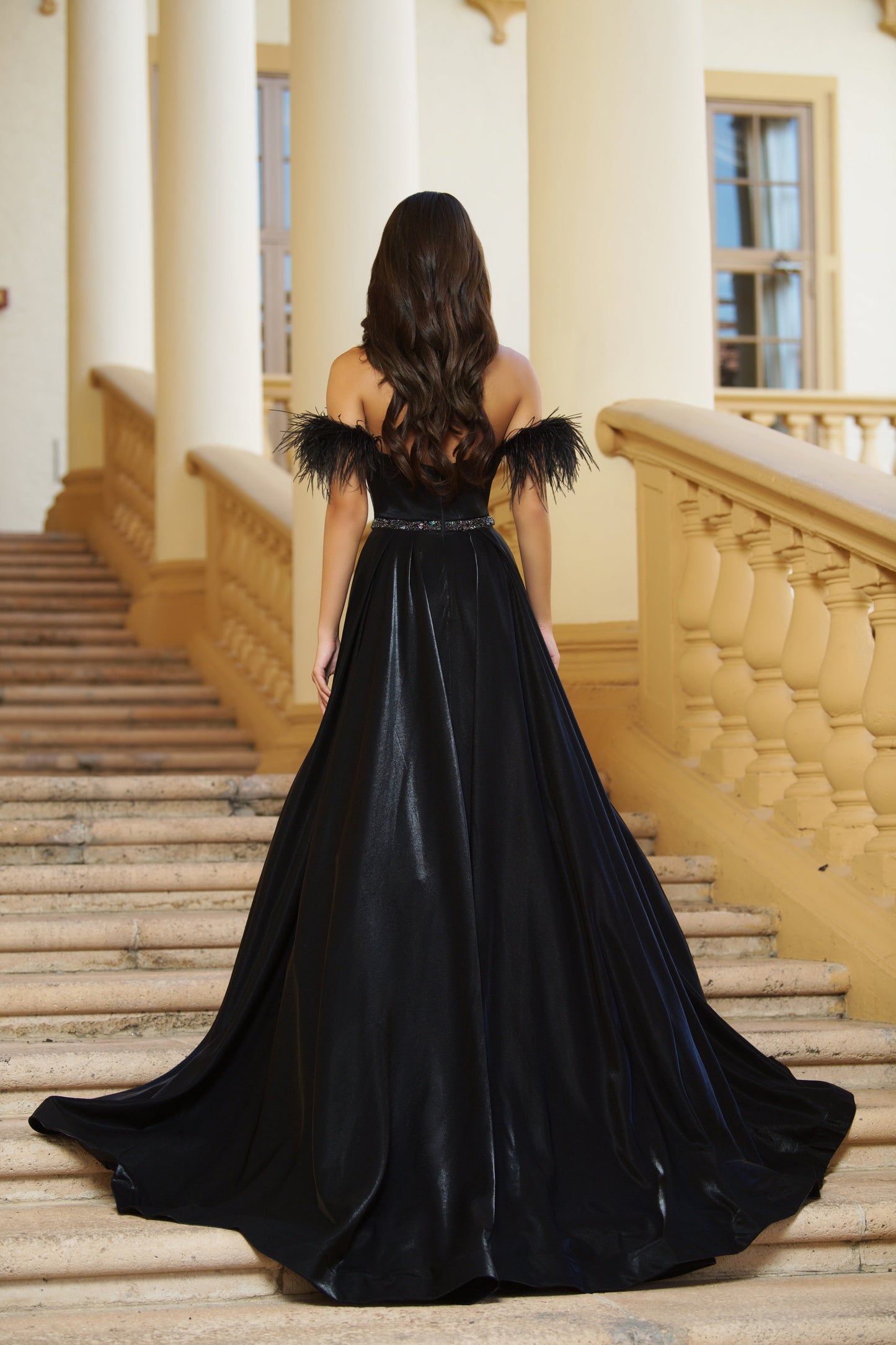 This classic ballgown from Ava Presley is crafted from lightweight fabric with off-the-shoulder feather straps. Featuring a fitted bodice and full A-line skirt, this elegant dress is perfect for formal occasions. Step out in style with this timeless formal gown.  Sizes: 00-24  Colors: Black, White, Coral Pink