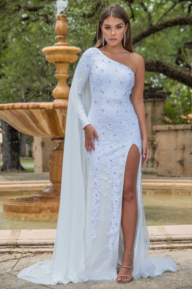 This stunning Ava Presley 28578 long prom dress features a one shoulder design with an intricate sequin pattern. The high slit and cape sleeve add a touch of elegance to this formal gown, making it perfect for any pageant or special occasion. Make a statement and stand out in style with Ava Presley.