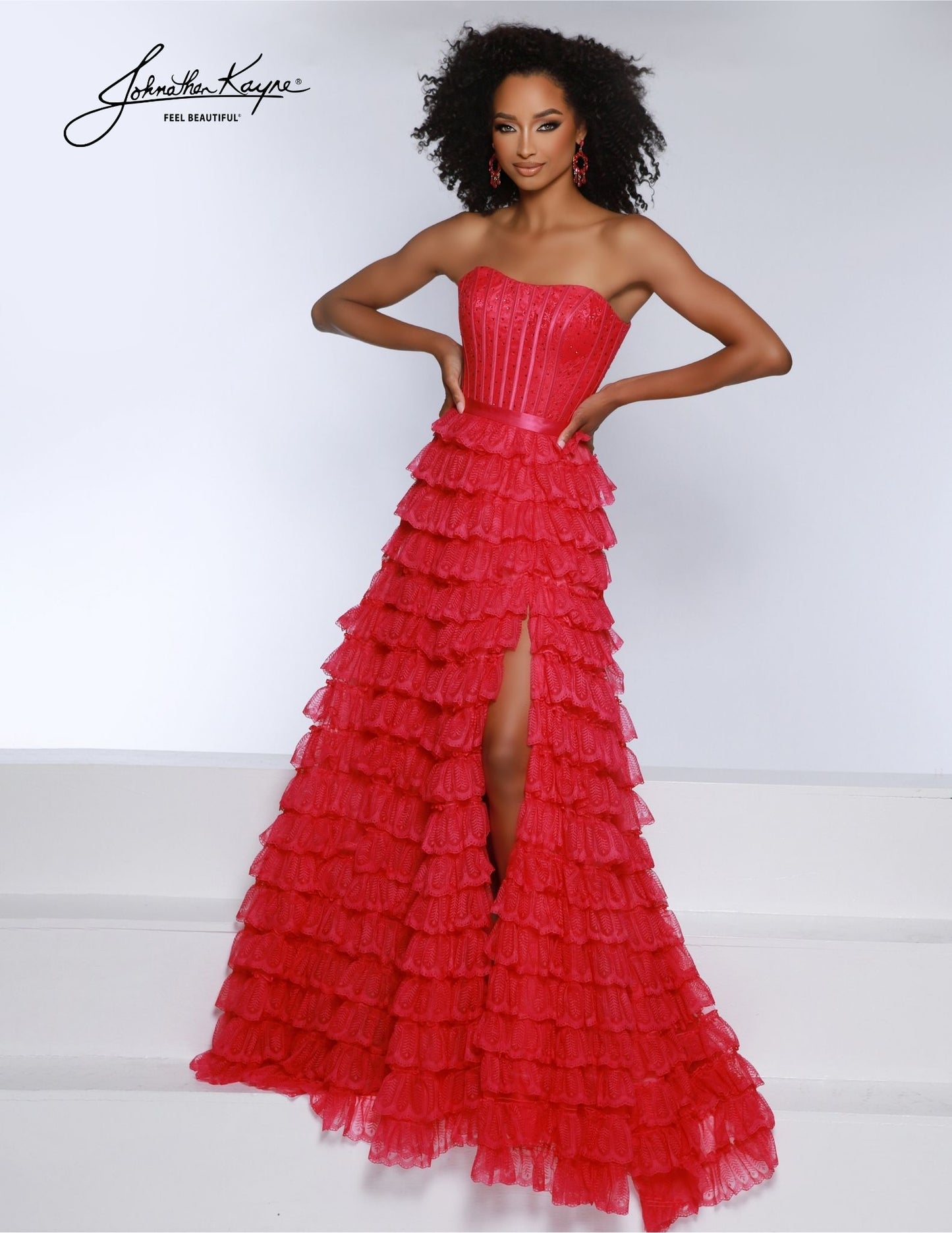 This Johnathan Kayne 2861 Long Prom Dress elegantly combines luxurious details like corset lace and ruffles with a strapless A-line silhouette. Perfectly crafted for formal occasions and pageants, it's the ideal gown for a sophisticated evening. Prepare to captivate in our strapless lace A-line gown. The cascading ruffles create an air of enchantment, while the exposed boning adds a touch of charm. The daring slit and corset back completes the look.