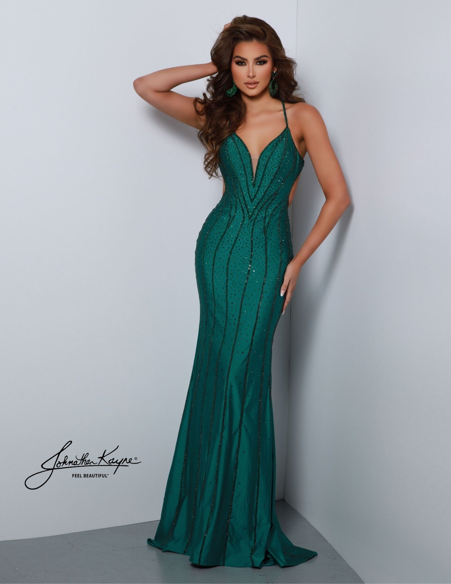 The Johnathan Kayne 2868 mermaid gown features a fitted plunging v-neckline and crystal accents for a stunning look. Perfect for formal occasions such as proms, pageants, or special events, the dress is sure to make an impact. The back takes center stage in this 4 Way Stretch Lycra gown. This gown features rows of crystal trim and a low back that is sure to steal the show and making sure you leave a lasting impression from every angle.