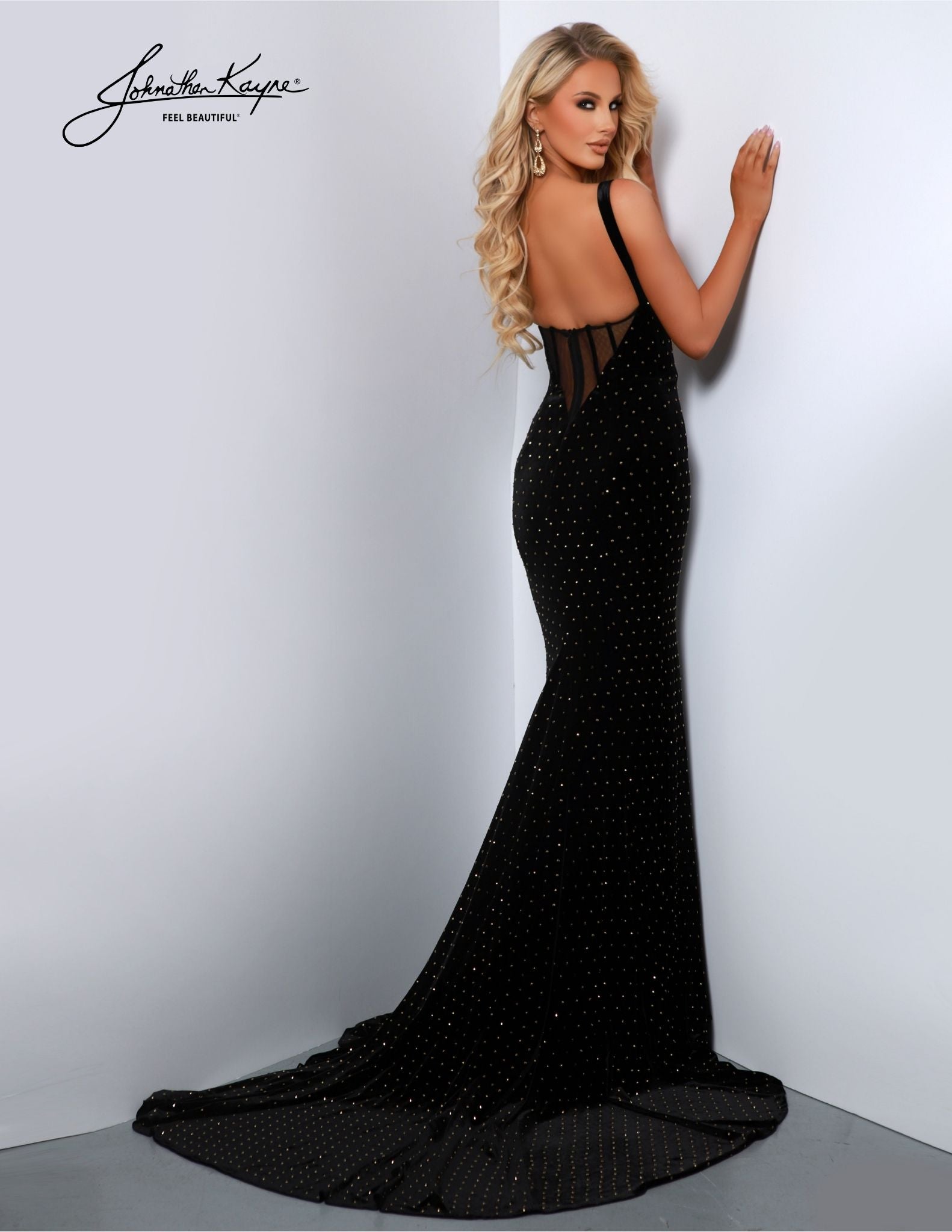 Make a dazzling entrance in this Johnathan Kayne 2871 long prom dress. Crafted from luxurious velvet, this sleek gown features a zipper front, open back, and high slit. A plunging V-neck adds to the drama, while a train accents the look. Perfect for any formal occasion. Elegance meets edginess in our stretch velvet dress, featuring a striking gold zipper and exposed boning back. The zipper is not just a functional element; it's a bold fashion statement.