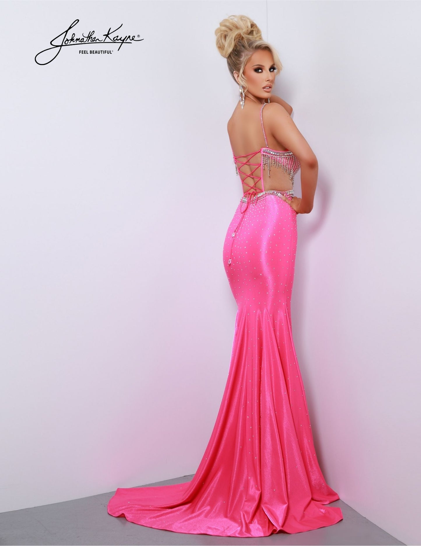Look elegant and feel your best in this Johnathan Kayne 2876 Long Prom Dress. Featuring a corset-style bodice with a plunging V neckline and a high slit, this pageant gown is sure to leave a lasting impression. The open back and cut out details give the dress a modern flair. Perfect for prom or any formal occasion. Prepare to shine and shimmy into the spotlight in our 4-Way Stretch Lycra gown. The rhinestone fringe bodice adds a touch of sparkle and movement that's perfect for the dance floor.