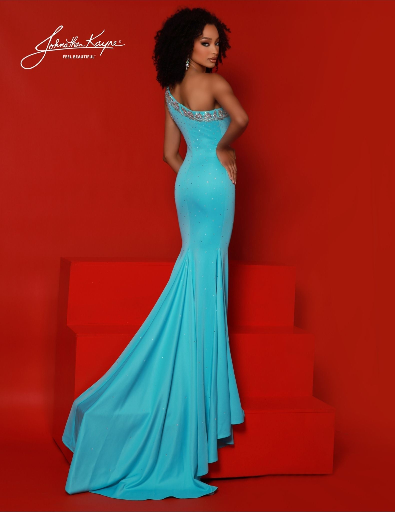 Expertly crafted by renowned designer Johnathan Kayne, this stunning prom dress, pageant gown, or formal evening wear is a must-have for any special occasion. The one shoulder design is embellished with sparkling crystals while the fitted silhouette is complemented by a sultry slit. Elevate your style and make a statement with this unique and elegant dress.