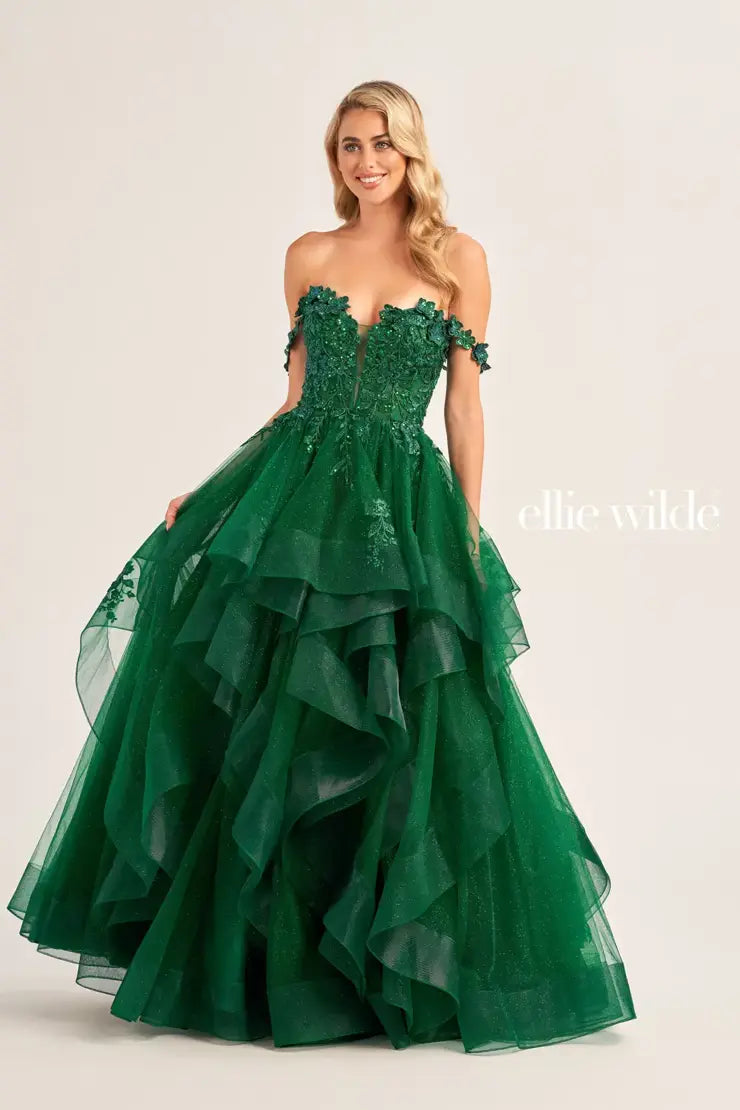 Make a statement in the Ellie Wilde EW35084 prom dress. Featuring an off-the-shoulder top, shimmer sequin lace and ruffle detail, the dress offers a timeless and sophisticated look perfect for the big night. Keep it classic in this classic formal gown.  Sizes: 00-24  Colors: EMERALD, ROYAL BLUE, TEAL, HOT PINK, BLUEBELL