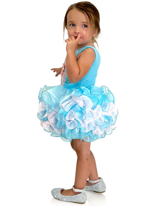 Marc Defang 5117K size 8 Turquoise girls cupcake pageant dress with pink applique on the top with crystal scattered throughout.  Multi blue and pink ruffle skirt.  Size 8  Color: Turquoise