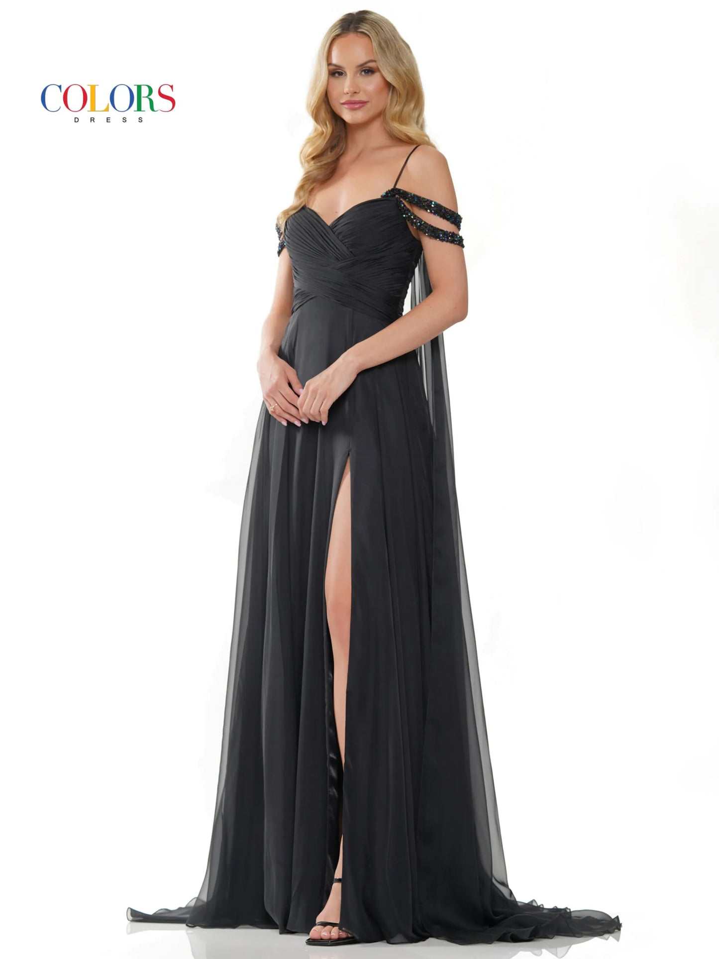 Elevate your style with the Colors Dress 3101 A Line Chiffon Pageant Dress. This stunning gown features an off the shoulder design and double beaded straps for a touch of elegance. The flowing chiffon cape adds a dramatic flair, while the maxi slit showcases your legs. Perfect for prom or any special occasion. corset back   Sizes: 0-20  Colors: Black, Royal, Deep Green, Hot Pink, Wine