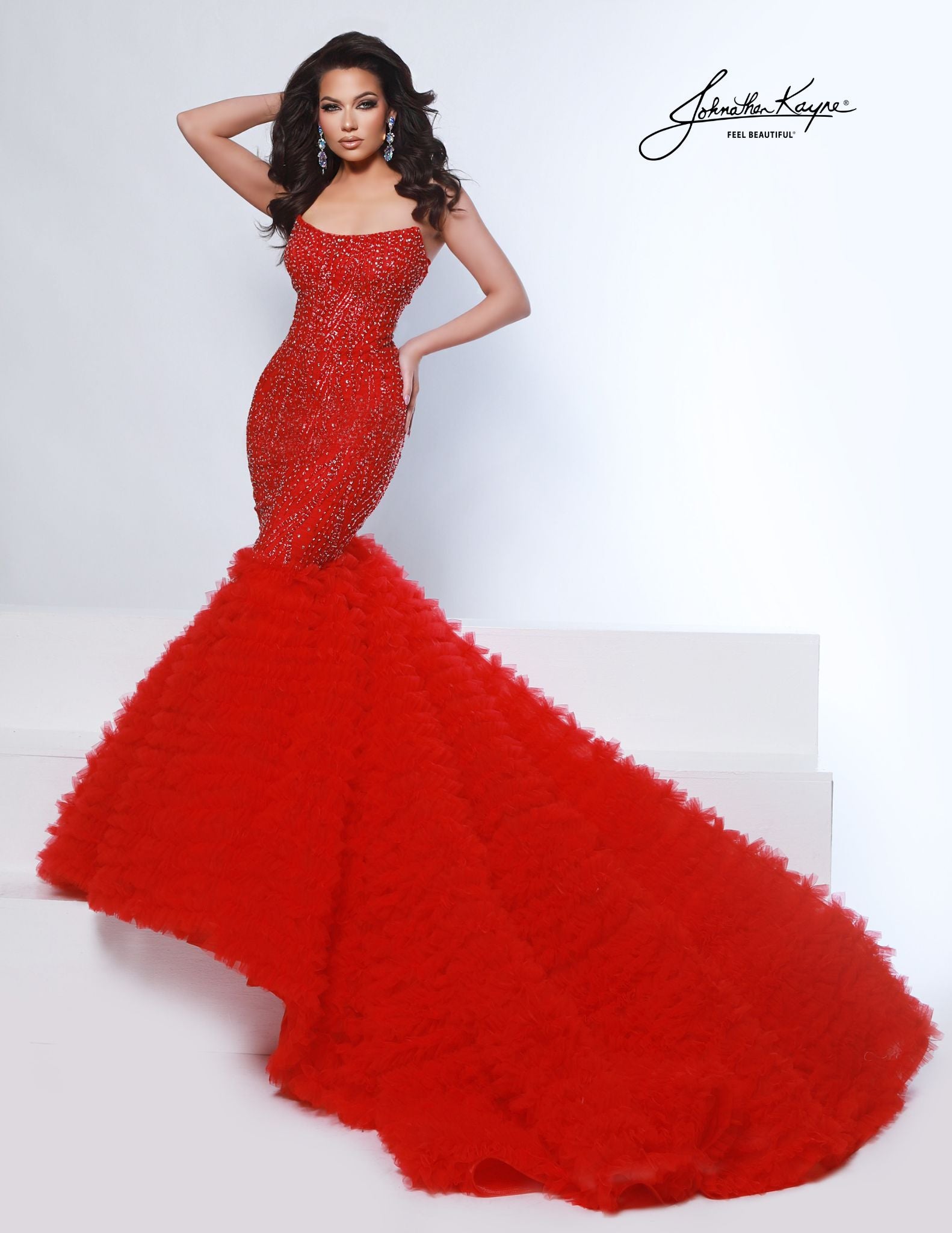 Elevate your special occasion with the Johnathan Kayne 3165 Mermaid Dress, featuring intricate beaded sequins that shimmer elegantly. This fitted gown highlights a sophisticated scoop neckline and a dramatic tulle ruffle handkerchief skirt with a graceful train, perfect for prom, pageants, or bridal events. Designed to flatter your silhouette, it combines timeless glamour with modern detail for a truly unforgettable look.

Sizes: 00-16

Colors: Red, White