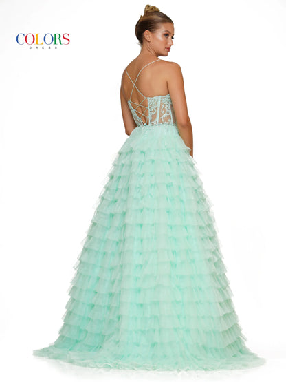Colors Dress 3219 is a formal gown featuring a long sheer lace embellished v neck corset with ruffled layers and an elegant ball gown skirt. Embellished details add a luxurious touch to the design, making it perfect for proms and special occasions.  Sizes: 2-24  Colors: Black, Light Blue, Mint, Pink