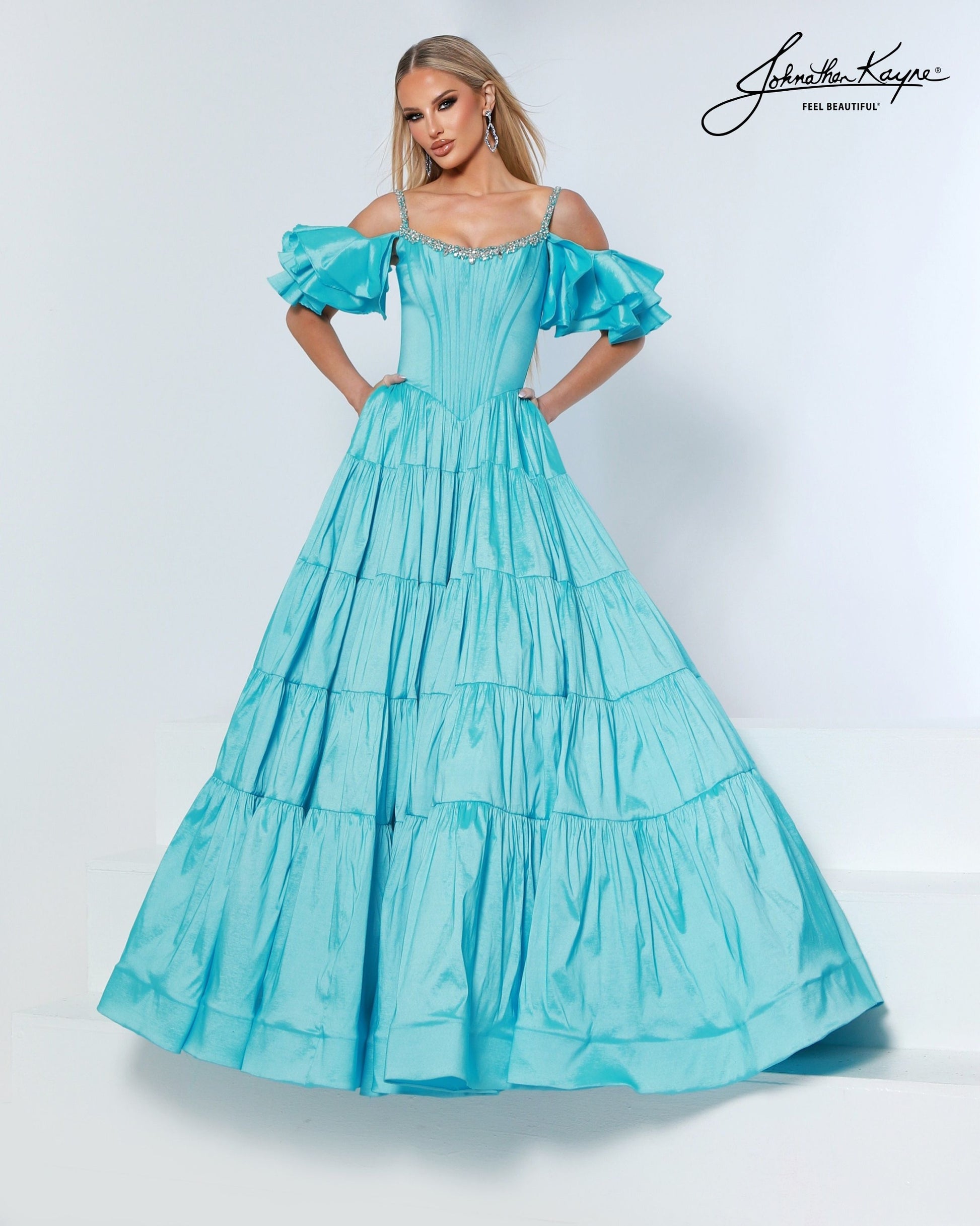 Designer: Johnathan Kayne — Style 3230
Johnathan Kayne style 3230 is a sleek long prom dress in a smooth, structured fabric that highlights the natural shape of the body. The clean lines and refined details make this gown a versatile choice for prom, pageant, and evening occasions that call for a polished, modern gown.

Sizes: 000, 00, 0, 2, 4, 6, 8, 10, 12, 14, 16
Colors: Aqua, Black, Petal Pink