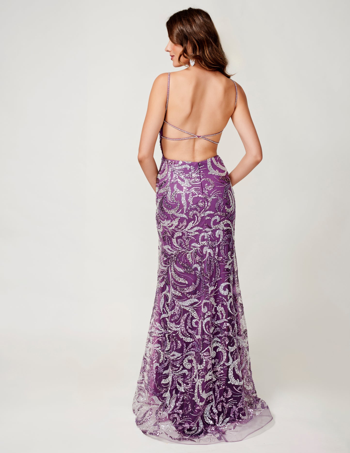 Nina Canacci presents an elegant formal dress for your next special occasion. With intricate beaded and sequin details, this backless gown features a stunning v-neck and thigh-high slit for a touch of glamour. Make a statement at prom or any evening event with this show-stopping design.