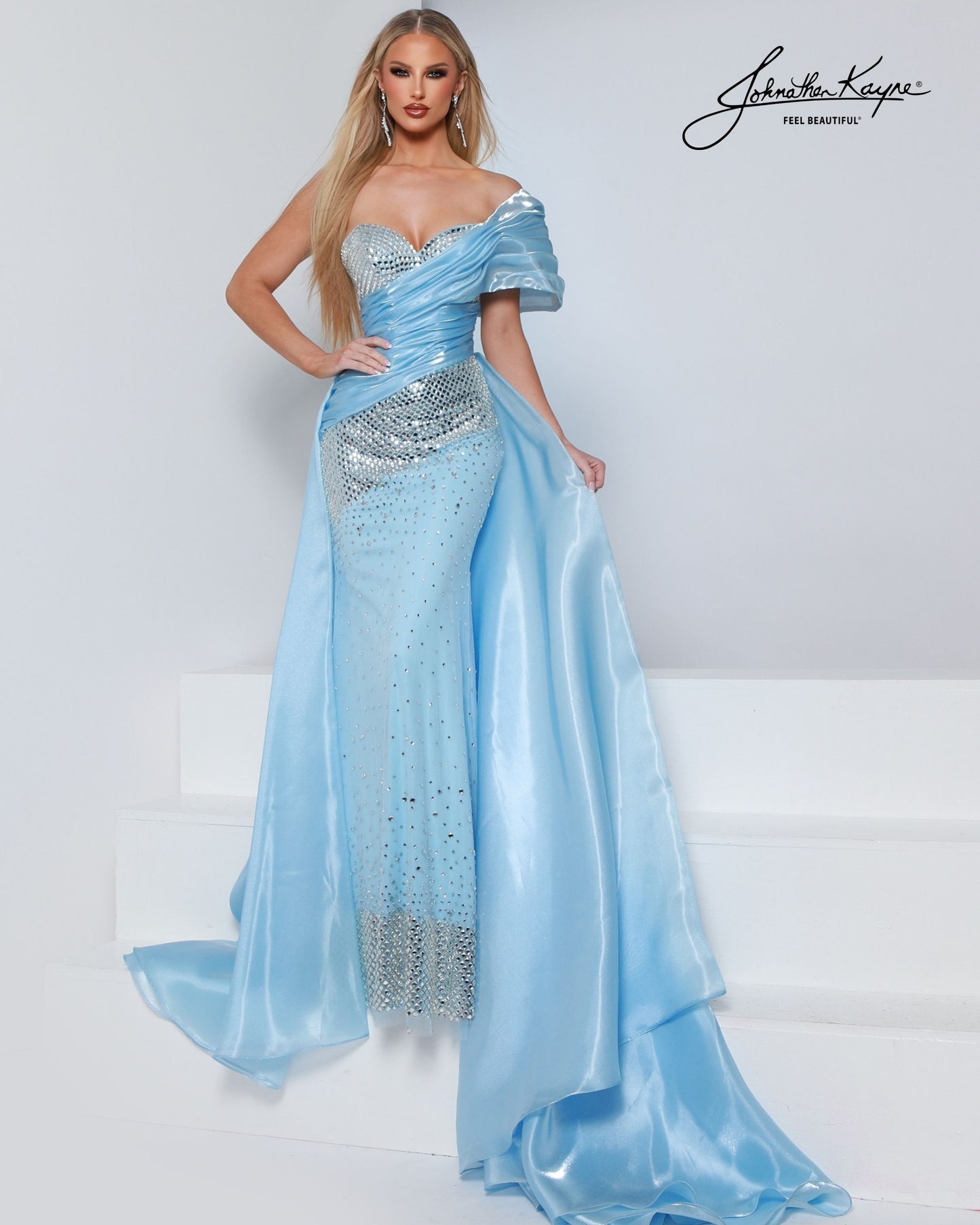 Designer: Johnathan Kayne — Style 3243
Style 3243 is a flowy Johnathan Kayne long prom dress crafted from lightweight special occasion fabrics for beautiful movement. The skirt glides effortlessly with every step, creating an elegant pageant dress silhouette that photographs beautifully and stands out on stage or on the dance floor.

Sizes: 000, 00, 0, 2, 4, 6, 8, 10, 12, 14, 16
Colors: Black, Cherry, Ice Blue, White