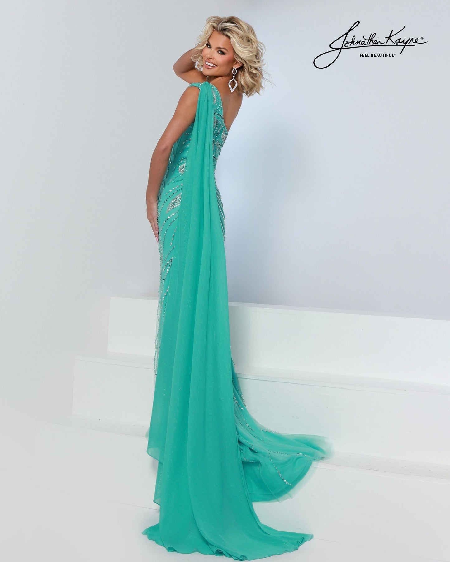 Designer: Johnathan Kayne — Style 3260
Style 3260 is a flowy Johnathan Kayne long prom dress crafted from lightweight special occasion fabrics for beautiful movement. The skirt glides effortlessly with every step, creating an elegant pageant dress silhouette that photographs beautifully and stands out on stage or on the dance floor.

Sizes: 000, 00, 0, 2, 4, 6, 8, 10, 12, 14, 16
Colors: Aqua, White