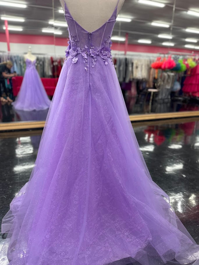 Elevate your evening with this Nina Canacci prom dress, featuring a delicate lilac lace overlay that shimmers subtly under the light. The A-line silhouette flatters with a graceful flow, while the V-neckline adds a refined touch. Intricate 3D floral appliqués adorn the corset bodice, creating a captivating blend of texture and elegance. Perfect for making a memorable statement at any formal event.

Size: 4

Colors: Lilac