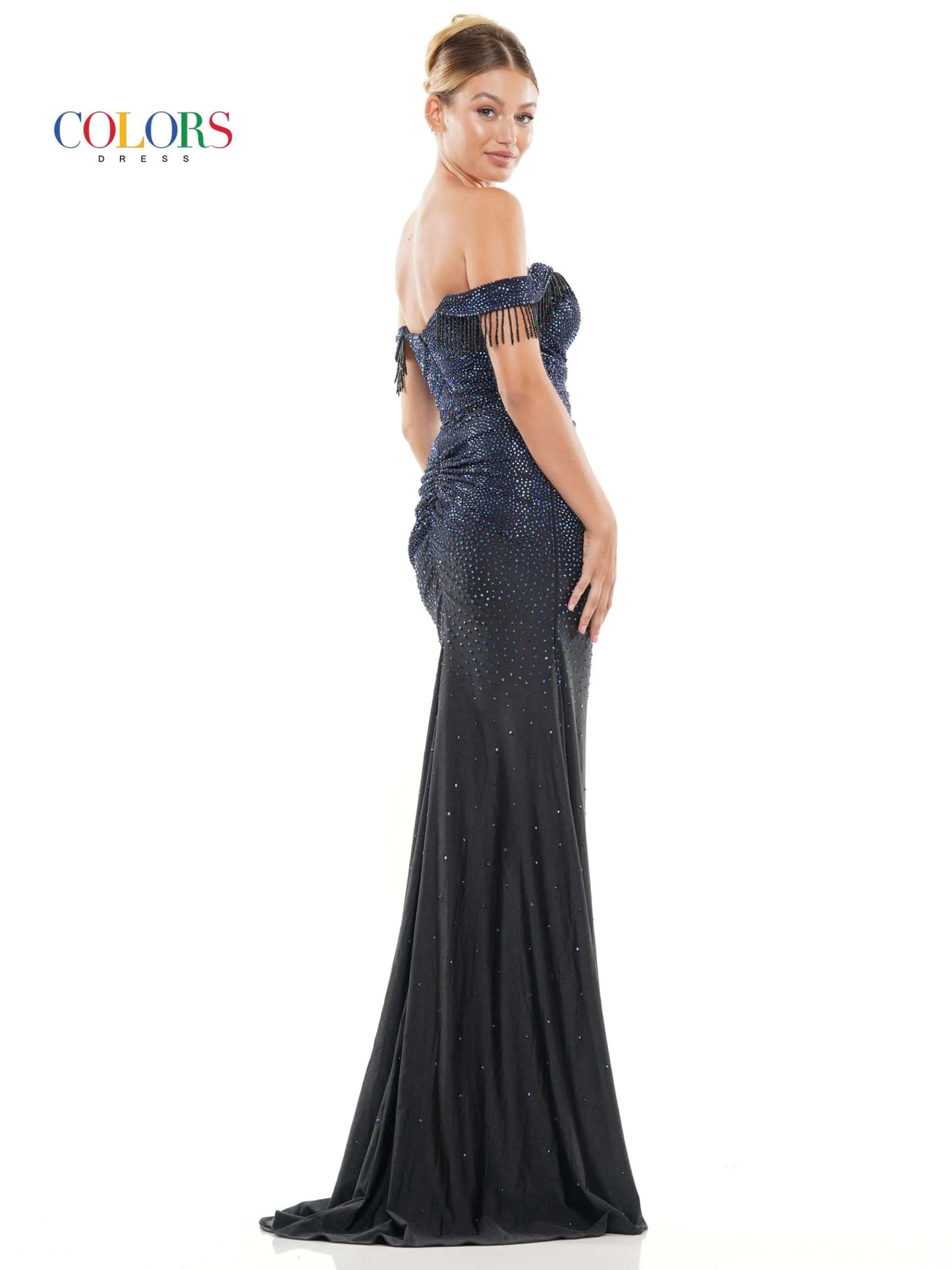 This glamorous formal dress from Colors Dress 3288 features off the shoulder fringe tassel sleeves, a crystal-studded bodice,  slit skirt, and a ruched waist detailing for a timeless and elegant look. Perfect for proms and special occasions.  Sizes: 0-22  Colors: Black, Deep Green, Turquoise