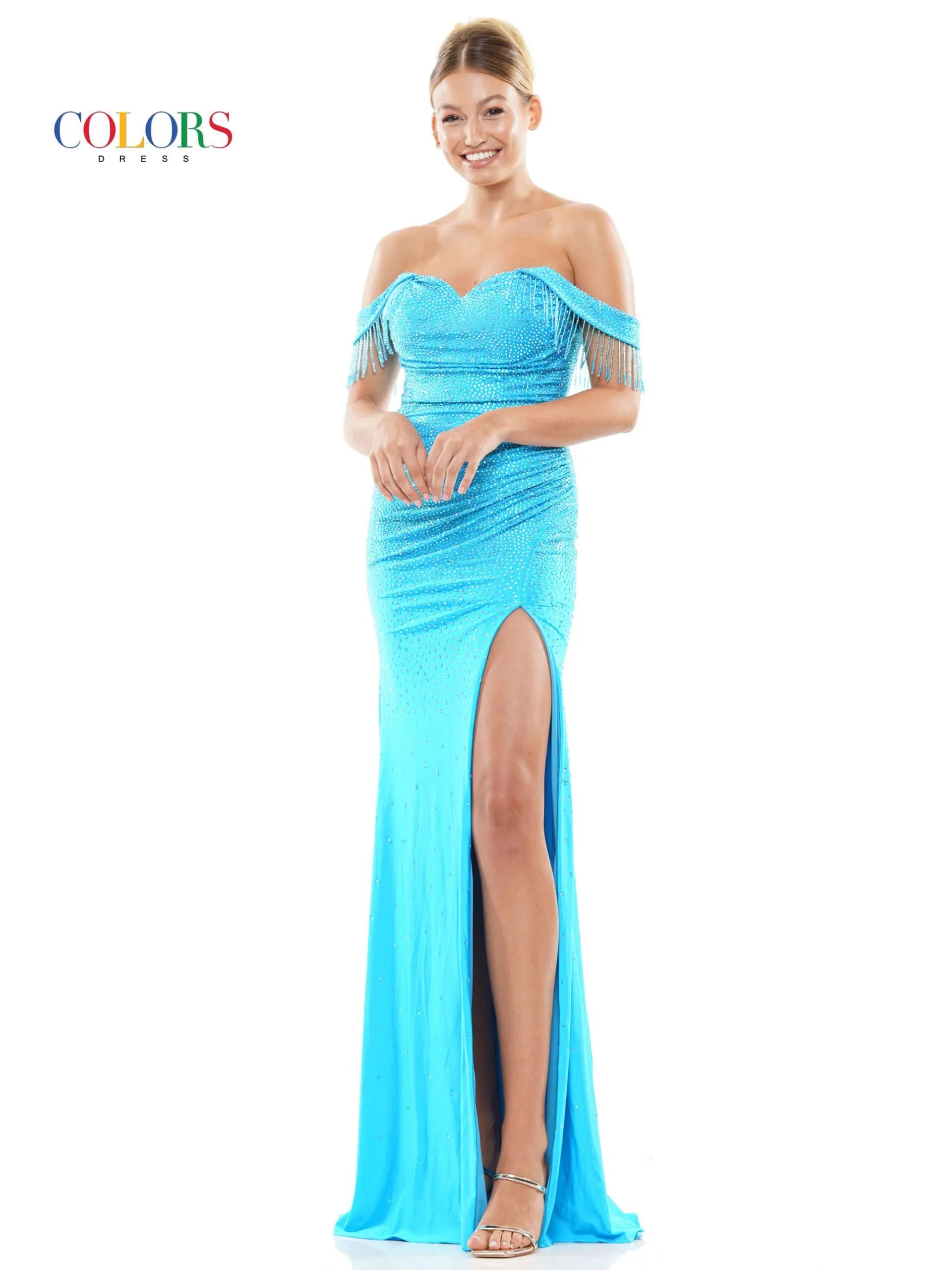 This glamorous formal dress from Colors Dress 3288 features off the shoulder fringe tassel sleeves, a crystal-studded bodice,  slit skirt, and a ruched waist detailing for a timeless and elegant look. Perfect for proms and special occasions.  Sizes: 0-22  Colors: Black, Deep Green, Turquoise