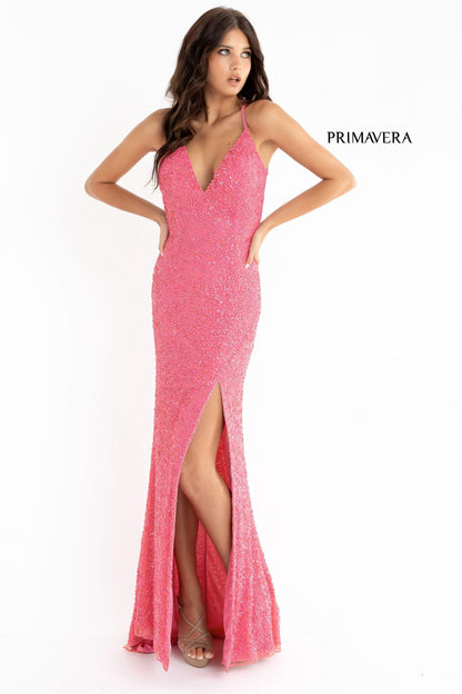 Primavera Couture 3291 Exclusive Prom Dresses.  This long prom dress is embellished throughout with shimmering sequins.  This impressive gown showcases a v neckline, thin beaded straps and crisscrossed straps in the open back. The long slim skirt has a sultry high side front slit. 