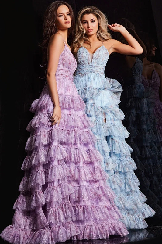 The Jovani 36571 is a vision of elegance in the formal collection. Crafted from mesh, this A-line prom dress showcases a delicate floral print, infusing the gown with a sense of whimsy and charm. The ruffle skirt adds a playful element, creating movement and enhancing the overall romantic aesthetic. A high slit in the skirt introduces an alluring touch, allowing for graceful movement.