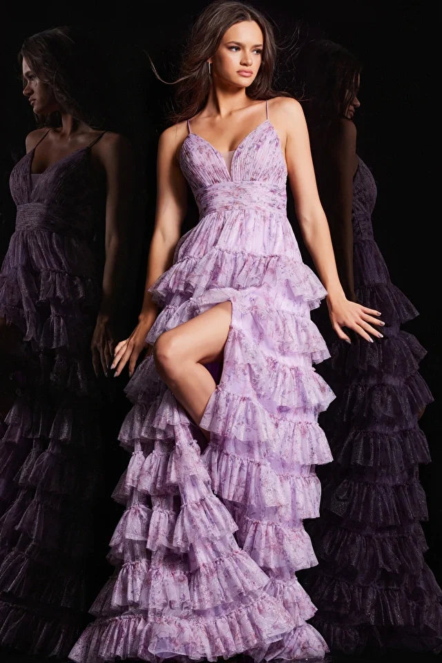 The Jovani 36571 is a vision of elegance in the formal collection. Crafted from mesh, this A-line prom dress showcases a delicate floral print, infusing the gown with a sense of whimsy and charm. The ruffle skirt adds a playful element, creating movement and enhancing the overall romantic aesthetic. A high slit in the skirt introduces an alluring touch, allowing for graceful movement.
