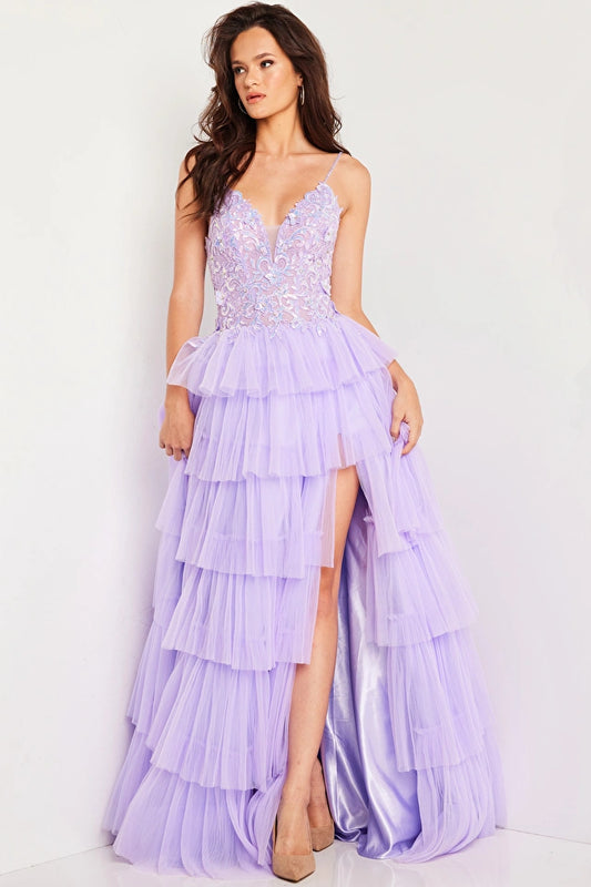 The Jovani 37190 is a part of their formal collection and is a truly exquisite prom dress. It is made from delicate tulle fabric and features an A-line silhouette. This floor-length gown has a pleated layered skirt with a daring thigh-high slit, which adds a touch of drama and allows for graceful movement.  The bodice of this dress is a showstopper, featuring intricate illusion embroidery embellished with stones and sequins. 