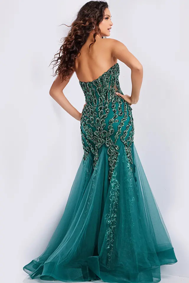 The Jovani 37142 is a captivating formal and prom dress designed to make a bold and glamorous statement. It is crafted from lightweight and delicate tulle fabric, known for its graceful drape and ethereal quality.  This gown features a mermaid silhouette, renowned for its dramatic, figure-hugging design that flares out at the bottom, adding an elegant and alluring touch to the overall look.