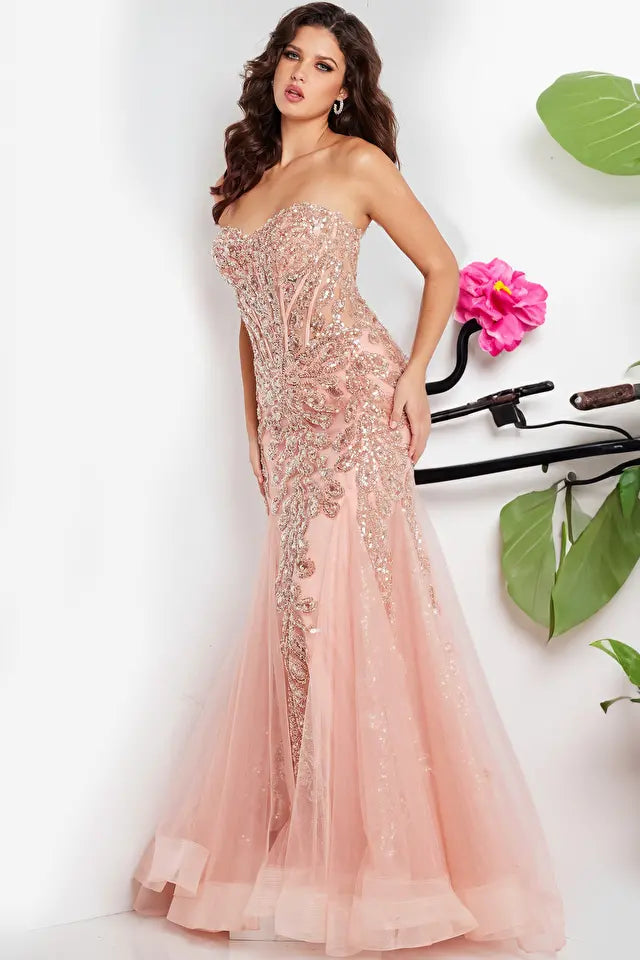 The Jovani 37142 is a captivating formal and prom dress designed to make a bold and glamorous statement. It is crafted from lightweight and delicate tulle fabric, known for its graceful drape and ethereal quality.  This gown features a mermaid silhouette, renowned for its dramatic, figure-hugging design that flares out at the bottom, adding an elegant and alluring touch to the overall look.