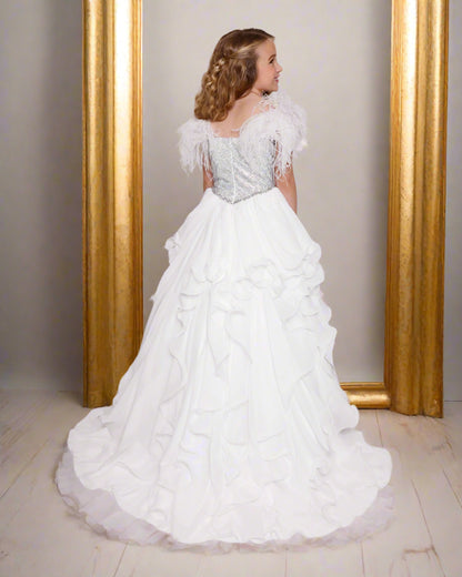 Experience elegance and beauty with the Ava Presley 38039 Feather Crystal Girls Pageant Dress. The lush feather shoulder straps and crystal embellished bodice exude sophistication, while the A-line skirt and ruffle details add a touch of playfulness. Perfect for any special occasion, this dress will make your little girl feel like a princess.