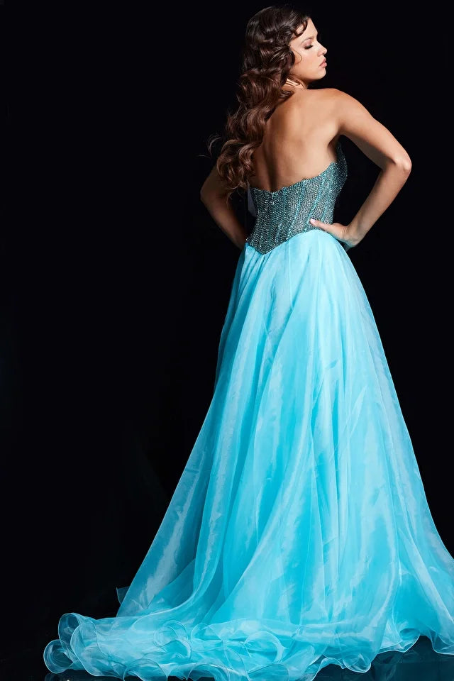 The Jovani 38179 is a captivating formal gown designed to make a statement at special occasions. It is made from organza, a lightweight and ethereal fabric that gives the dress a graceful quality. The dress features an A-line silhouette, which is timeless and universally flattering, with a gently flared skirt that flows to the floor. The gown includes a high slit, adding a touch of drama and allure to the design.