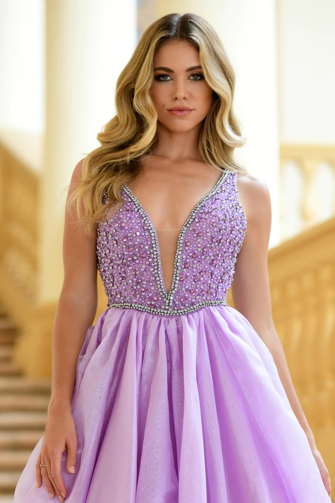 The Ava Presley 38342 A Line Beaded V Neck Ballgown is the perfect choice for your next pageant, prom, or formal event. With stunning beaded detailing and a flattering A line silhouette, this gown will turn heads and make you feel like a true queen. The V neck adds an elegant touch, while the train adds a touch of drama. Make a statement with this gorgeous dress.  Sizes: 00-16  Colors: Lilac, White, Ice Blue, Periwinkle