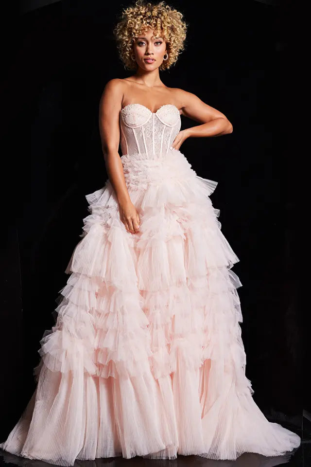 The Jovani 38540, a captivating prom dress from the formal collection, exudes elegance and grace. Crafted from a combination of tulle and lace, the A-line silhouette is adorned with a ruffle-embellished skirt, imparting a sense of movement and playfulness. The corset sheer bodice, featuring boning for structural support, adds allure to the ensemble.  Intricate lace details and a beaded bust grace the bodice, introducing a hint of sparkle and sophistication. 