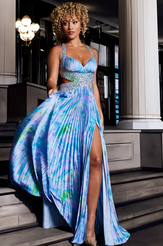 The Jovani 38722 gown is a showstopper that seamlessly blends elegance with a touch of drama, perfect for formal events and prom night. Crafted from lustrous satin, this gown exudes sophistication and grace. Its flowy style and exquisite details set it apart, making it a standout choice for any special occasion. The captivating print adds a unique and vibrant element to the gown, while pleats and a high slit in the skirt create movement and allure.